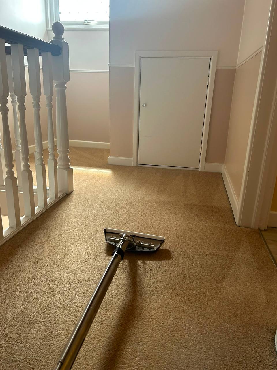 Carpet extraction cleaning in progress on a landing
