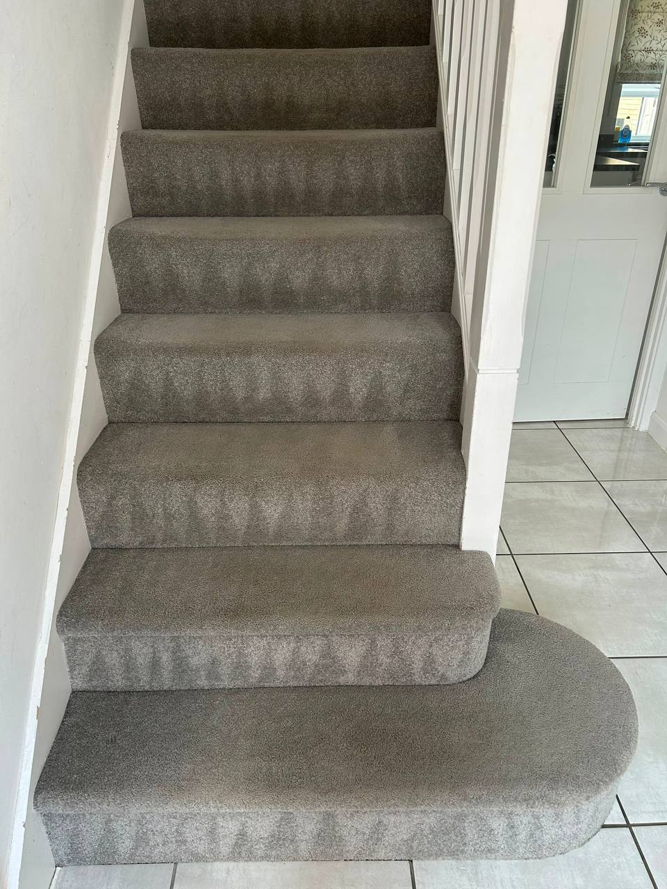 Freshly cleaned taupe stair carpet